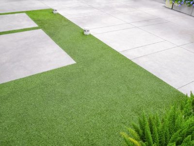 Artificial Turf With Gravel Stone Pavement Decoration And Ornamental Plant In Home Gardening Area
