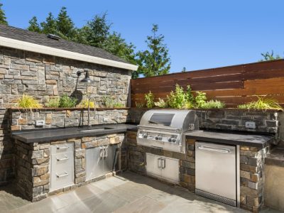 Backyard Hardscape Patio With Outdoor Barbecue And Kitchen