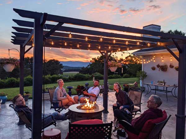A Family Relaxing Around A Fire Table In Outdoor S 2025 03 11 18 21 20 Utc 1 Scaled 1