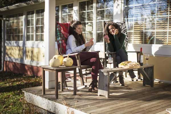 Two-young-female-friends-playing-card-game-on-pati-2025-04-04-07-49-07-utc-1024x683 Why Fall Is the Best Time to Start Your Hardscape Project